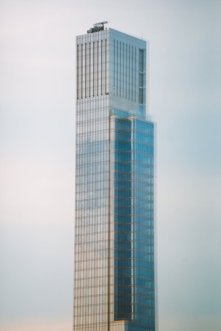 A tall building with a glass facade in the distance