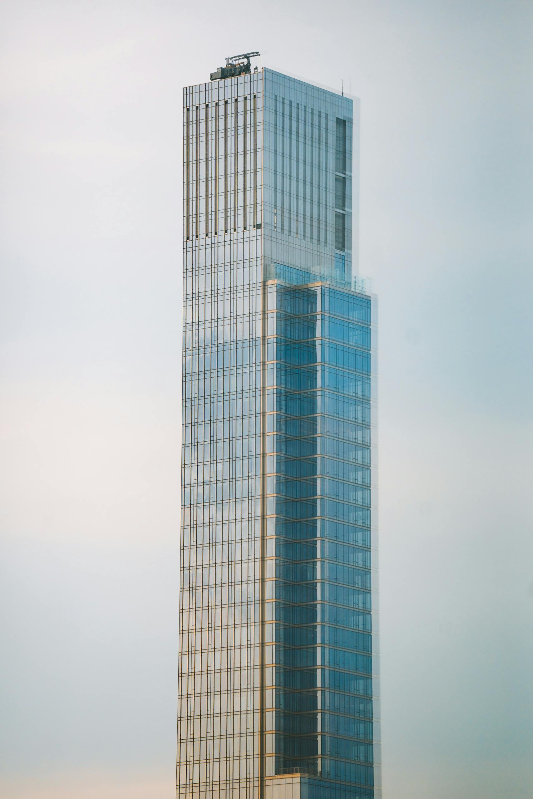 A tall building with a glass facade in the distance