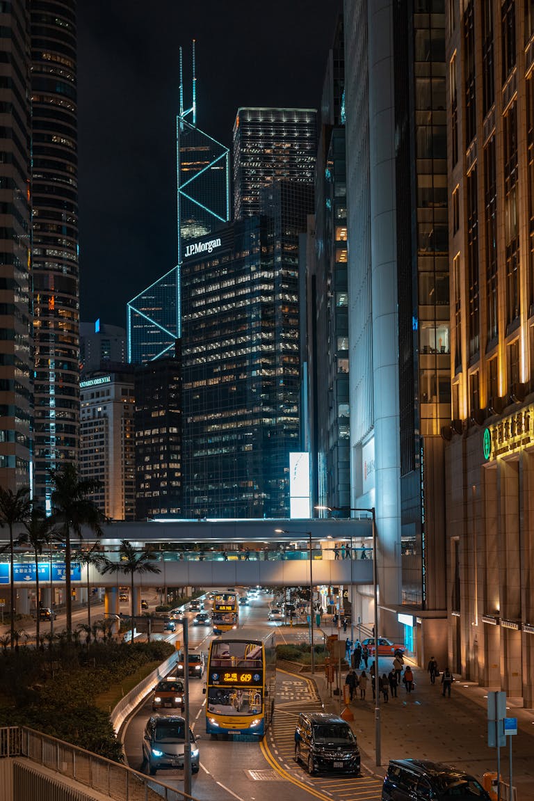 A bustling Hong Kong cityscape highlighting skyscrapers and busy streets at night.